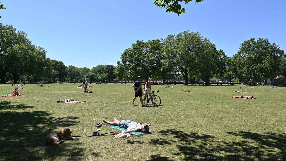 People enjoy the hot weather in London Fields park in east London