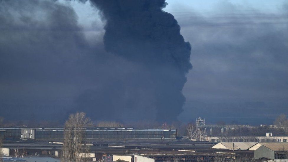 Black smoke rises from a military airport in Chuhuyev near Kharkiv on February 24, 2022