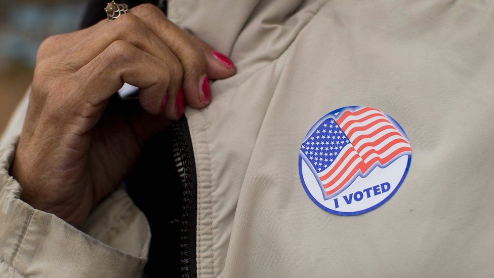 A voter shows off her 'I Voted' sticker as she leaves a polling place on November 4, 2014 in Ferguson, Missouri.