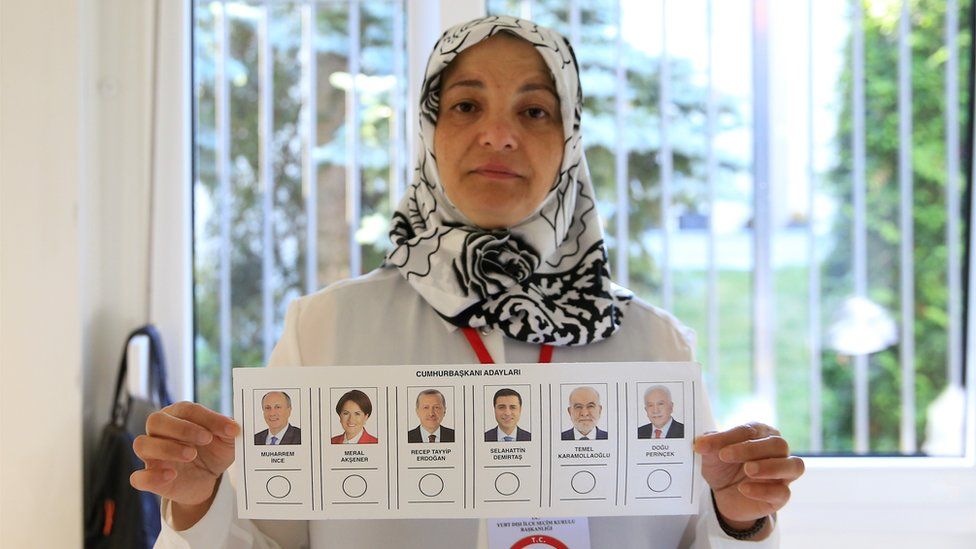A returning officer shows a voting paper for the Presidential and General elections in Turkey, at a polling station at Turkey Consulate-General in Berlin on June 07