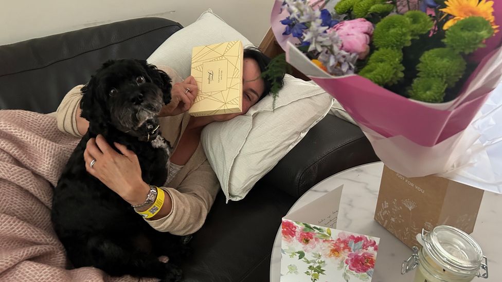 Lucy Owen lying down with her dog Buddy