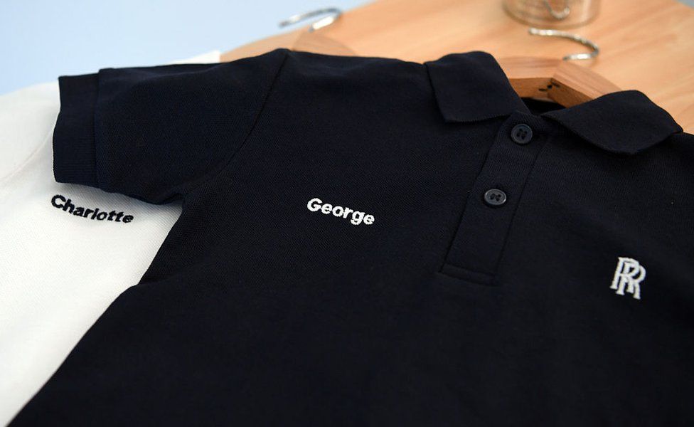 Personalised shirts for Prince George and Princess Charlotte lie on a table after being given to Prince William, Duke of Cambridge as he visits the Rolls Royce XWB engine assembly line at the Rolls Royce factory on November 30, 2016 in Derby, England.