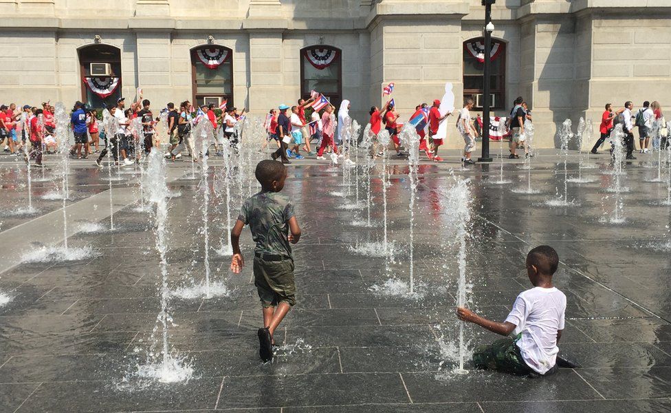 Children pay at city hall fountains during demonstration