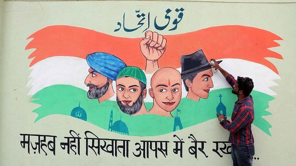 Sabahat Nabeel Qadri, an art teacher of National Urdu High School Kalyan gives final touch to the wall paintings of social messages on the schools wall, on May 3, 2019 in Mumbai, India.