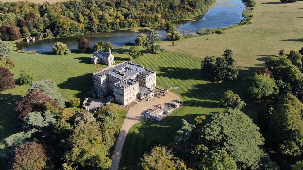 A stately home surrounded by parklands and ponds
