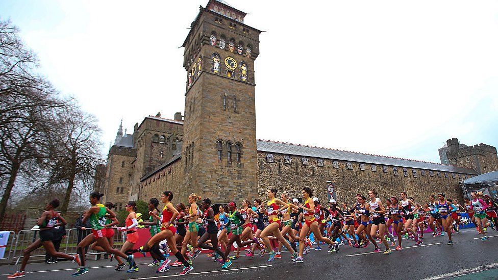 Runners running past Cardiff Castle