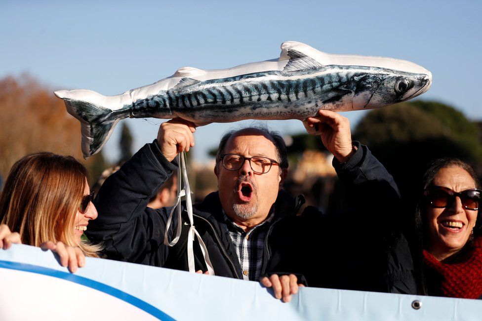 Men take part in the "Sardine Movement" rally in Rome, 14 December