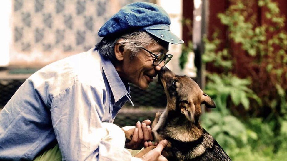 A dog kisses Masanori Hata on the nose in this photo on his Instagram page.