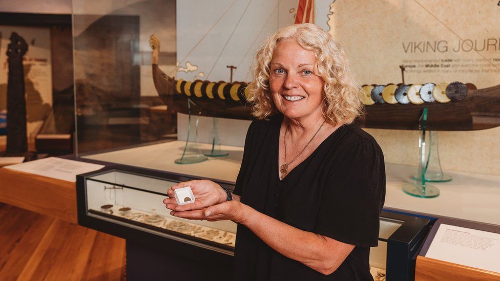 Kath Giles holding one of the Viking coins