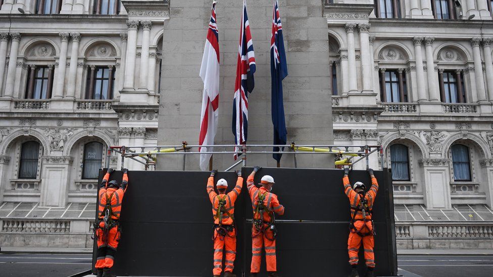 Workers erect a protective barrier around the Cenotaph in anticipation of protests tomorrow