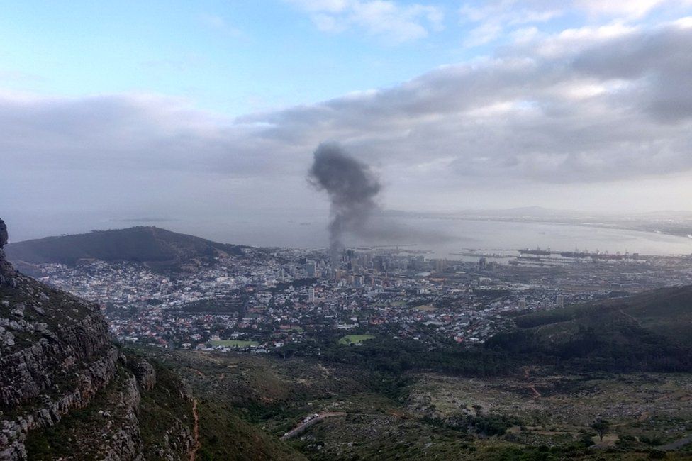 Smoke rises from a burning building in Cape Town, South Africa, on 2 January 2022, in this picture obtained from social media