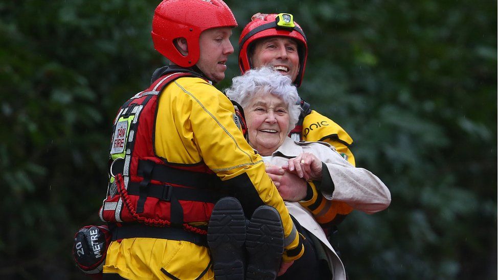 An elderly resident is evacuated from a flooded house in Nantgarw, south Wales