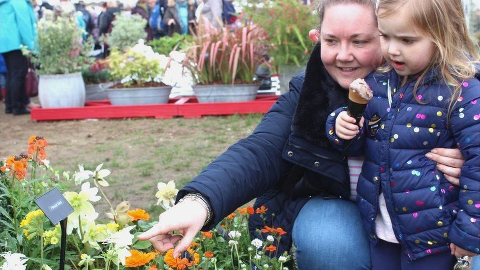 Three-year-old Anabelle enjoying some ice cream whilst learning about flowers from her mum, Helen