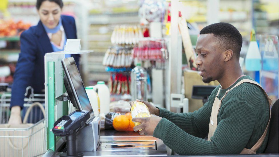 Man checking out goods in a supermarket