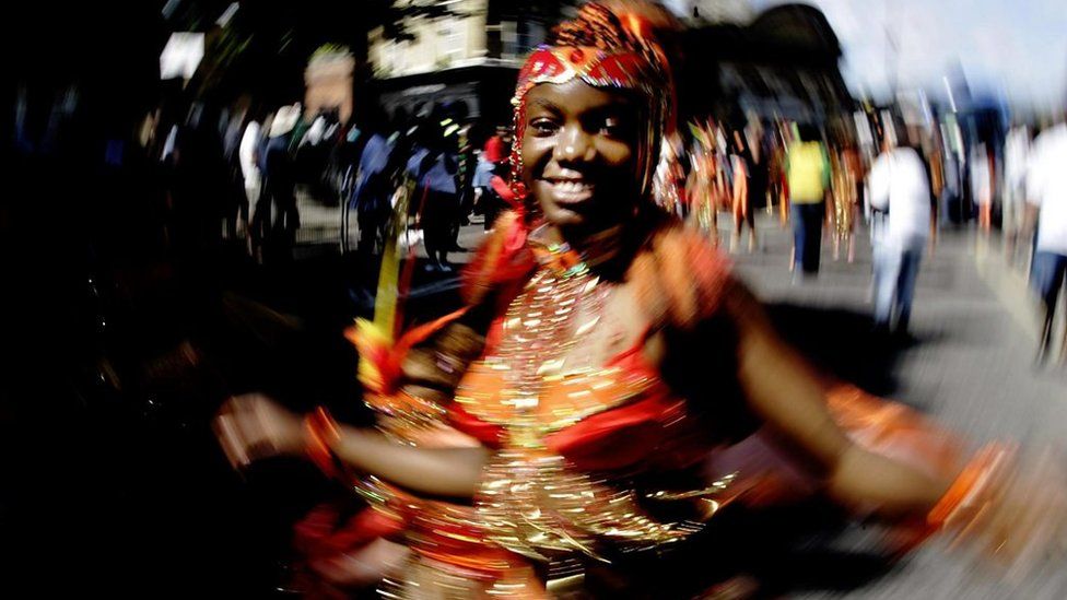 A woman dancing at the Notting Hill Carnival