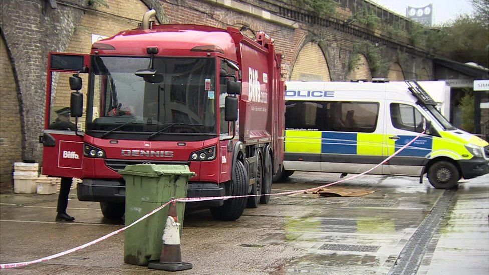 Bin lorry and police van