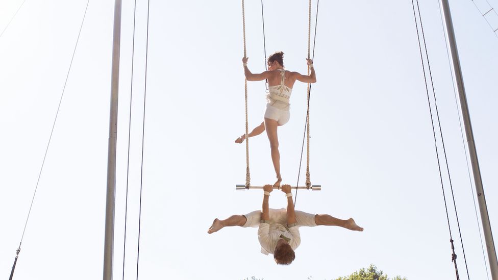 Two people on a trapeze