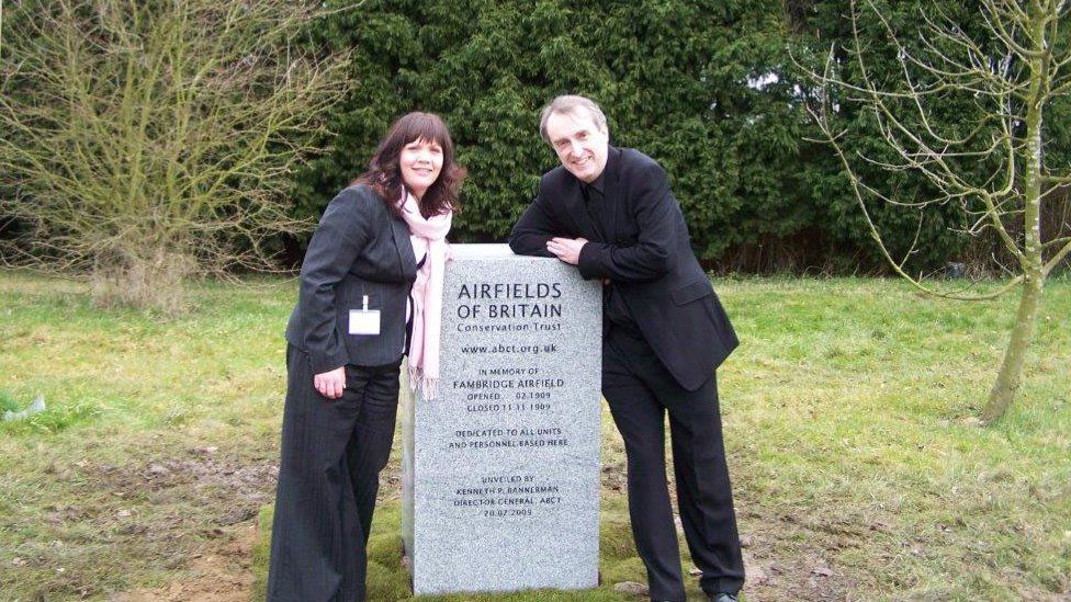 ABCT trustee Lynda Coxon with ABCT director-general Kenneth Bannerman standing at a memorial
