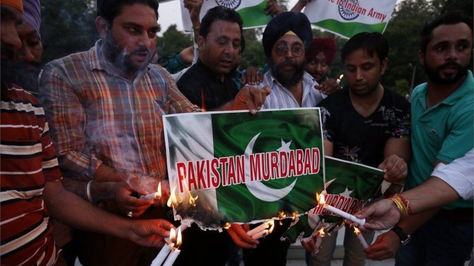 Members of National Human Rights and Crime Control Organization burn posters of the Pakistan flag with the slogan "Pakistan Murdabad" ("Down with Pakistan") printed on them, as they pay tribute to Indian Army soldiers who lost their lives in an attack on an Indian army camp in Uri, in Amritsar, India,