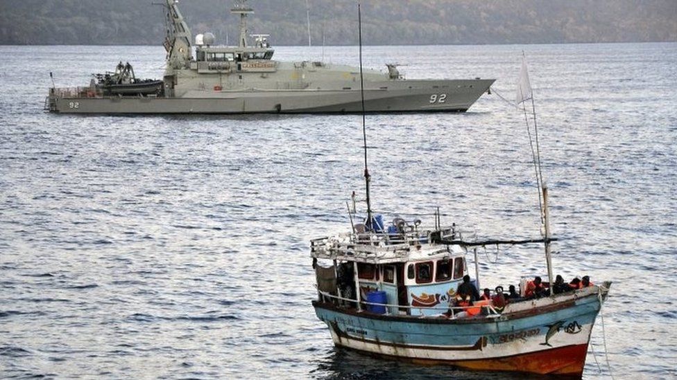 Asylum seekers who arrived by boat escorted by Australian navy patrol boats are moored in Flying Fish Cove, Christmas Island, Australia, 16 August 2012