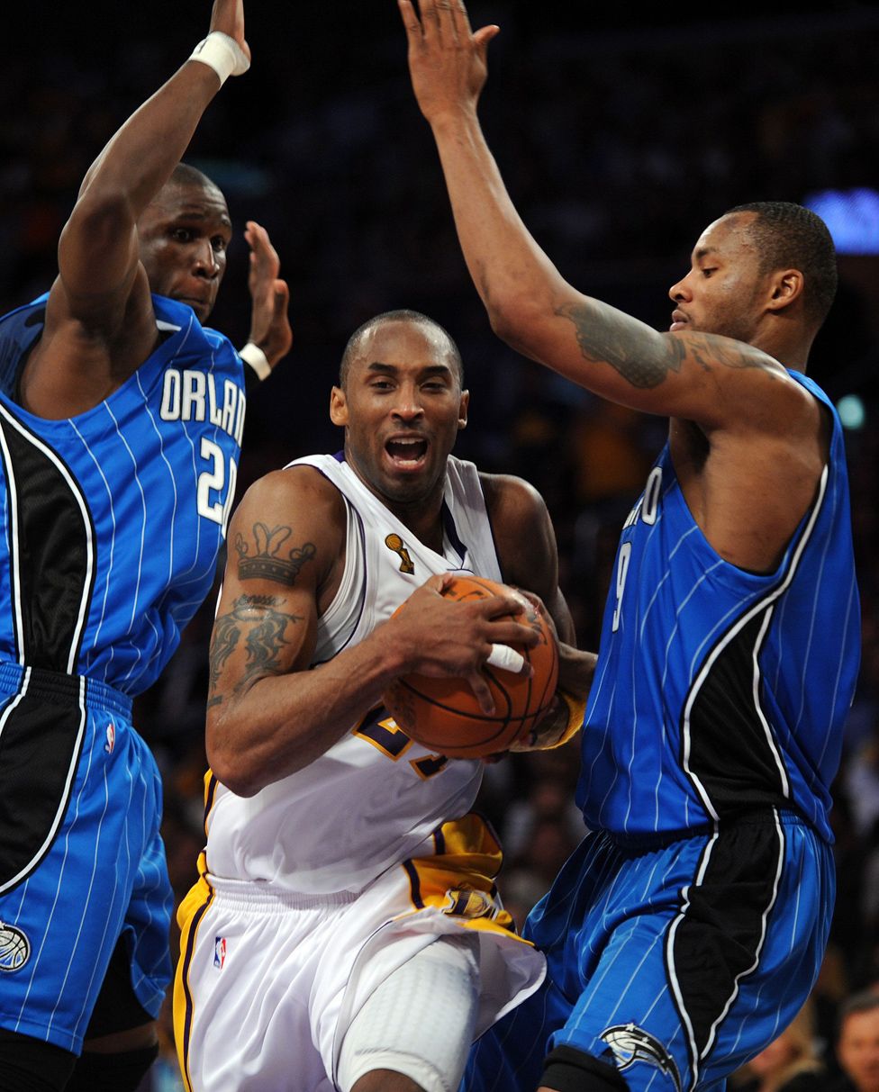 Kobe Bryant outpasses Orlando Magic's Mickael Pietrus and Rashard Lewis during the NBA final between Los Angeles Lakers and Orlando Magic.
