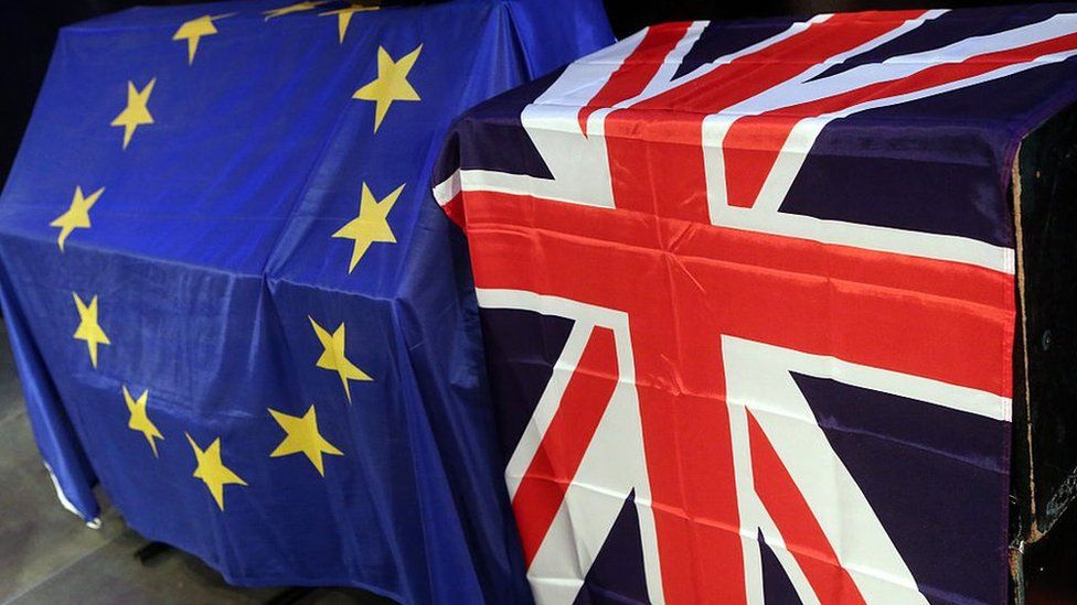 European Union (L) and British Union Jack flags hang at a meeting for British citizens living in Germany to discuss the implications of Great Britain leaving the European Union