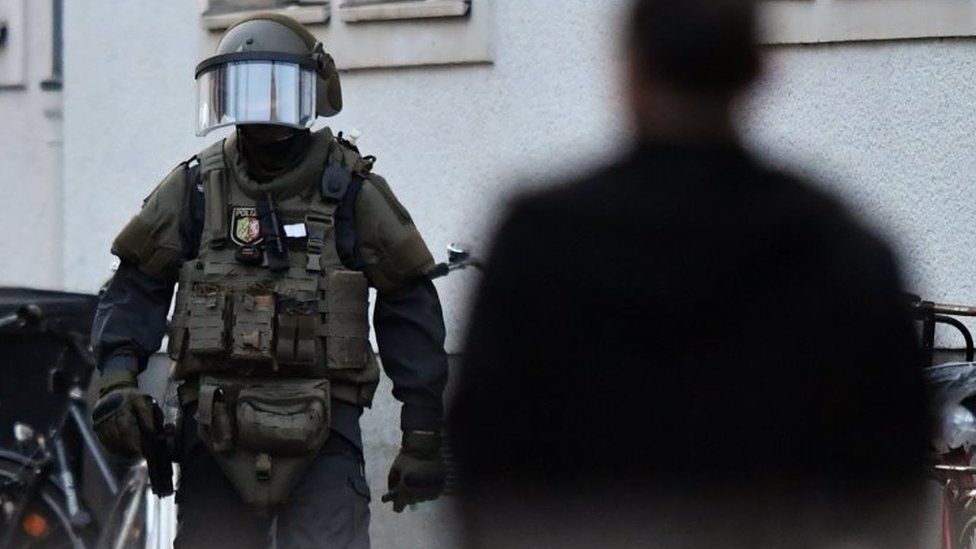 Highly armed police officer wearing specialist protective gear