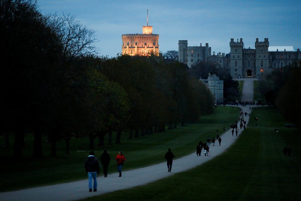 People gather to bring flowers after Britain"s Prince Philip, husband of Queen Elizabeth, died at the age of 99, in Windsor, near London, Britain, April 9, 2021. REUTERS/Andrew Boyers