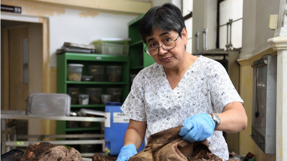 Forensic pathologist Raquel Fortun examines bones of Duterte drug war victims in Manila