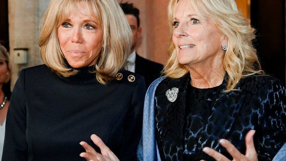 US first lady Jill Biden gestures next to French first lady Brigitte Macron as they meet during a visit to Rome for the G20 summit, in Rome, Italy, October 29, 2021