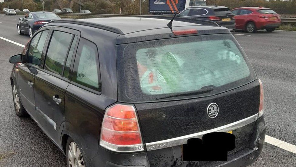 Vehicle stopped on the motorway hard shoulder filled with luggage in the rear