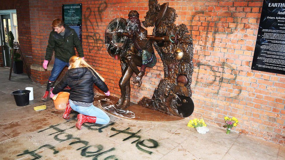 Volunteers cleaning the David Bowie Statue