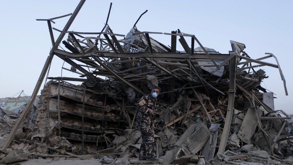 A member of Afghan security force investigates at the site of an explosion near the German consulate office in Mazar-i-Sharif, Afghanistan November 11, 2016.