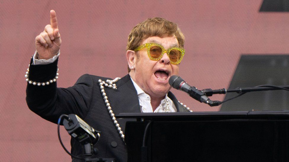 Elton John singing and playing the piano at Norwich gig