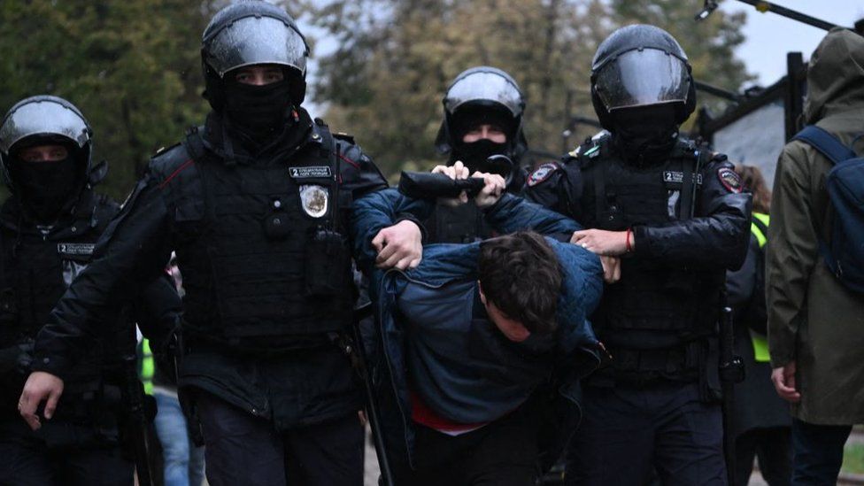 A man is arrested by security forces