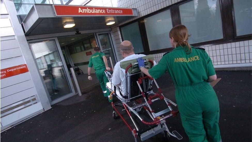 Patient being wheeled into A&E by paramedics