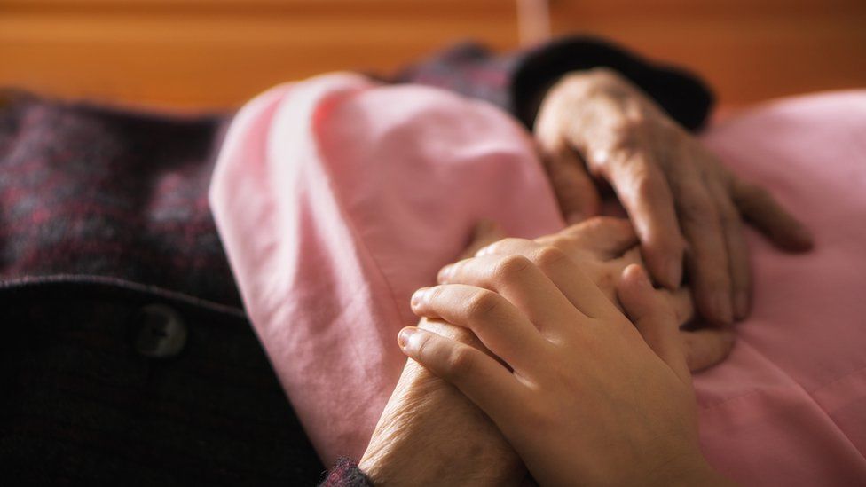 An elderly person being cared for