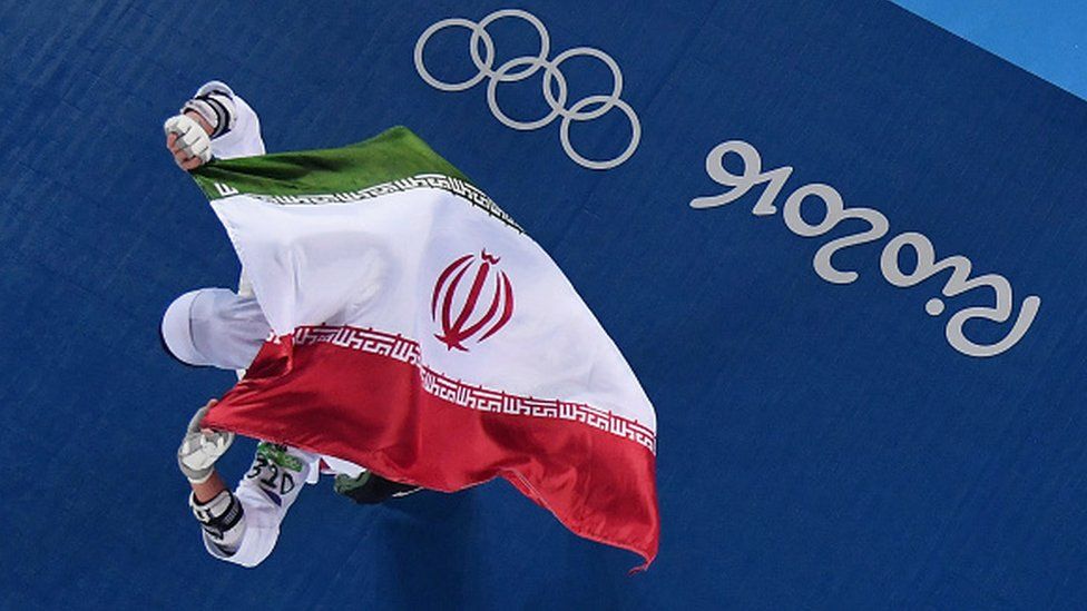 Kimia Alizadeh Zenoorin of the Islamic Republic of Iran celebrates after defeating Nikita Glasnovic of Sweden at the 2016 Olympic Games