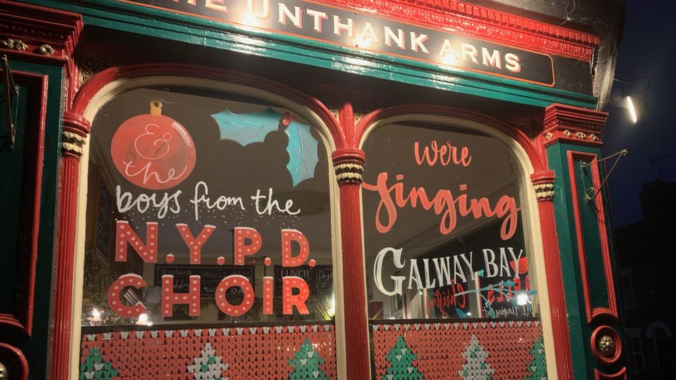 Pub windows with Fairytale of New York lyrics painted on them