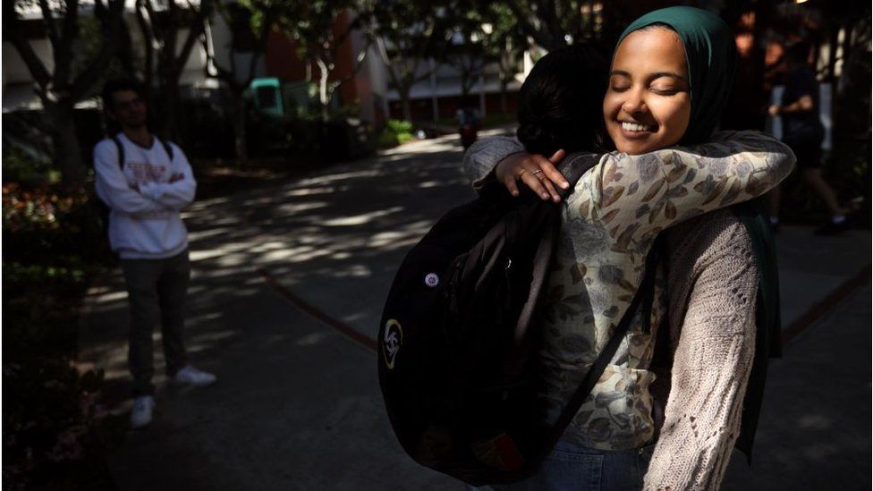Student Asna Tabassum receives a hug of support after her speech invitation was rescinded