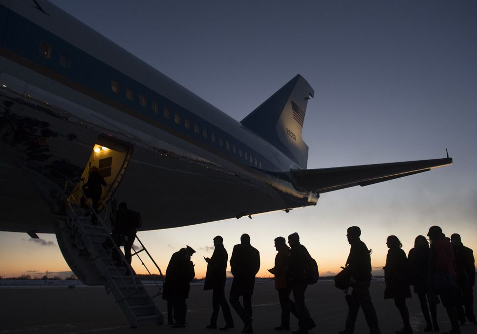 Reporters and staff board Air Force One prior to departure from Detroit Metropolitan Wayne County Airport in Romulus, Michigan, January 7, 2015