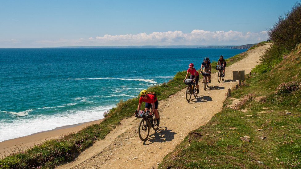 Cyclists riding along the West Cornwall coast