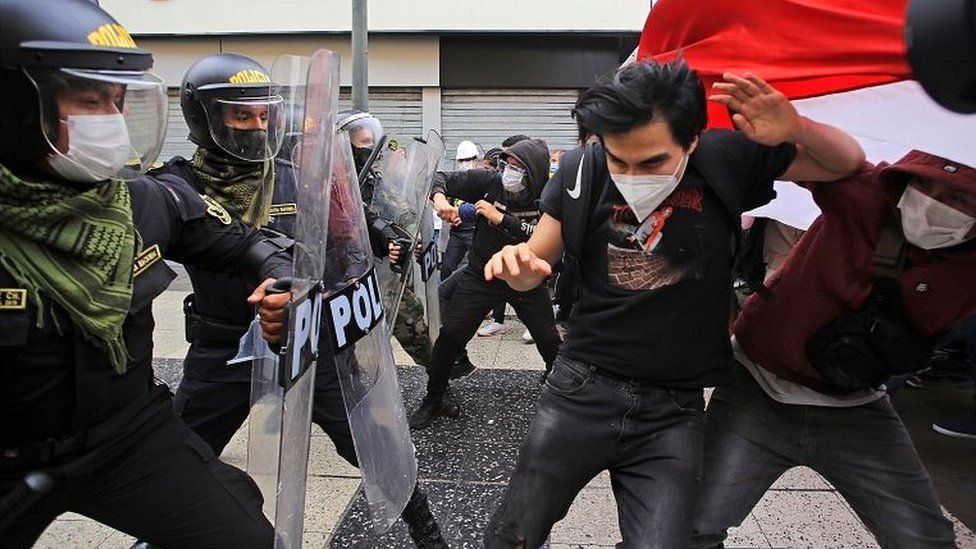 Demonstrators clash with police during a protest in Lima, Peru, on 10 November 2020