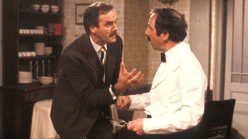 John Cleese as Basil Fawlty and Andrew Sachs as Manuel in Fawlty Towers