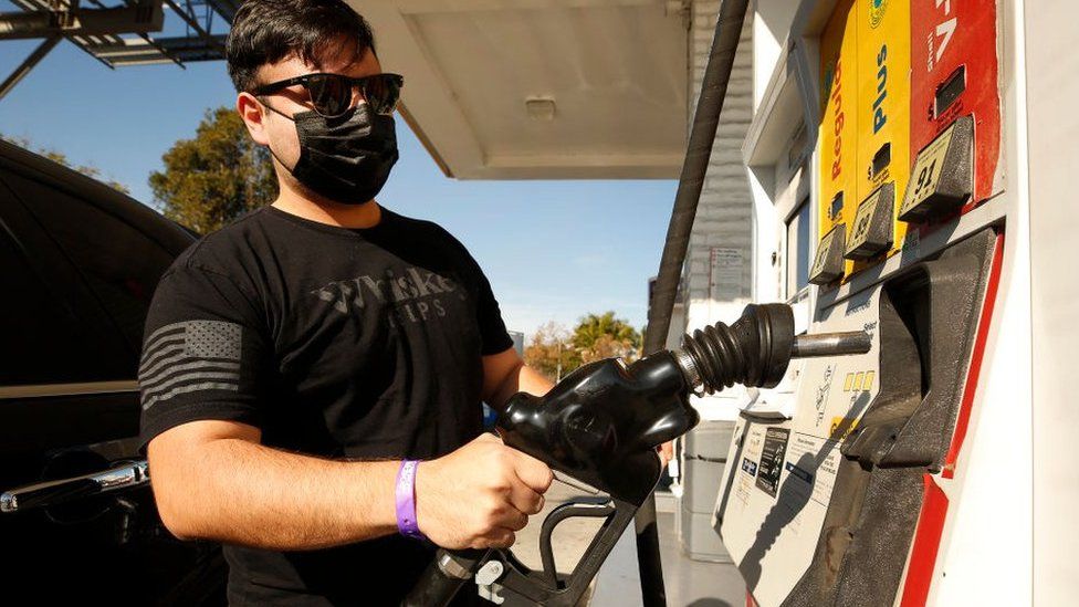 Man fills up his car with petrol at a Shell station in California.