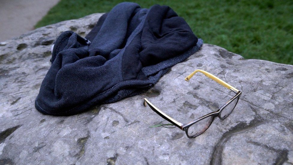 A child's glasses and a jacket lie on a rock in the Parc Monceau, after a lightning strike in Paris, May 28, 2016