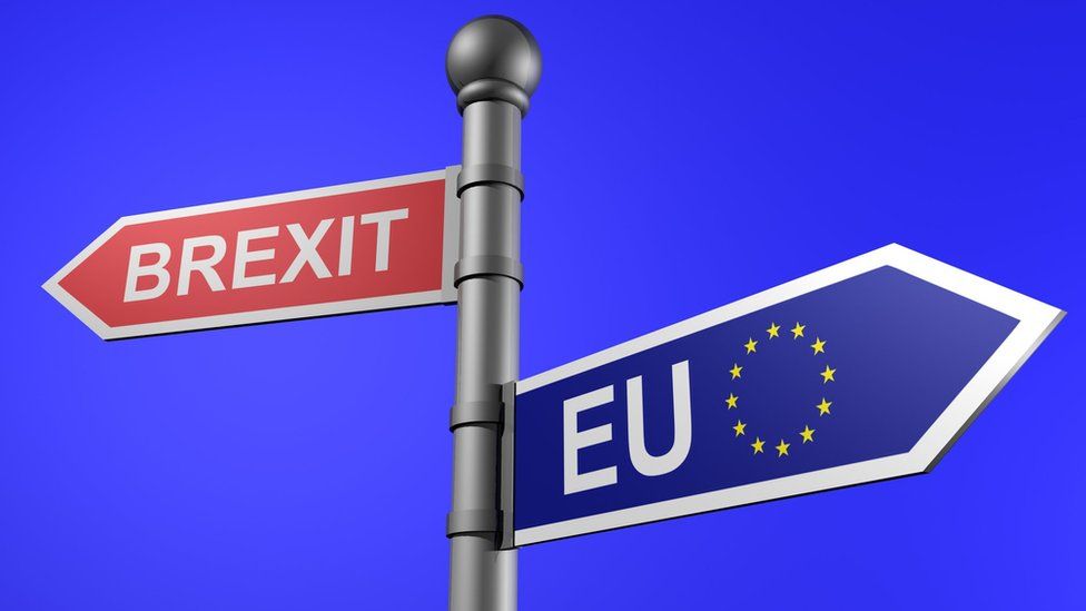 A road sign pointing to the EU and Brexit