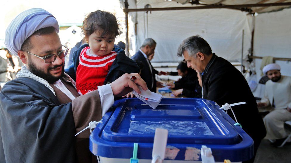 Iranians cast their ballot at a polling station in Shah Abdol-Azim Shrine, 21 February