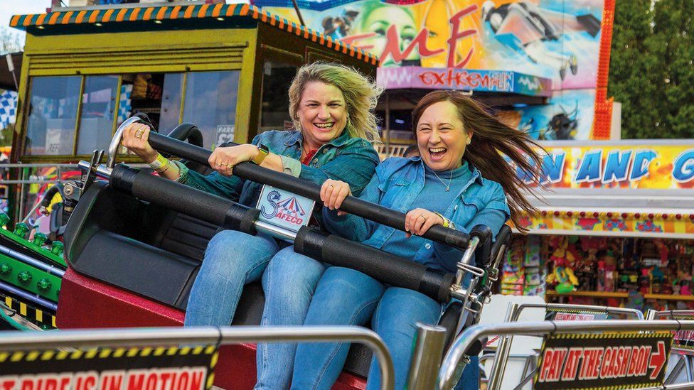 Two women on a fair ground ride