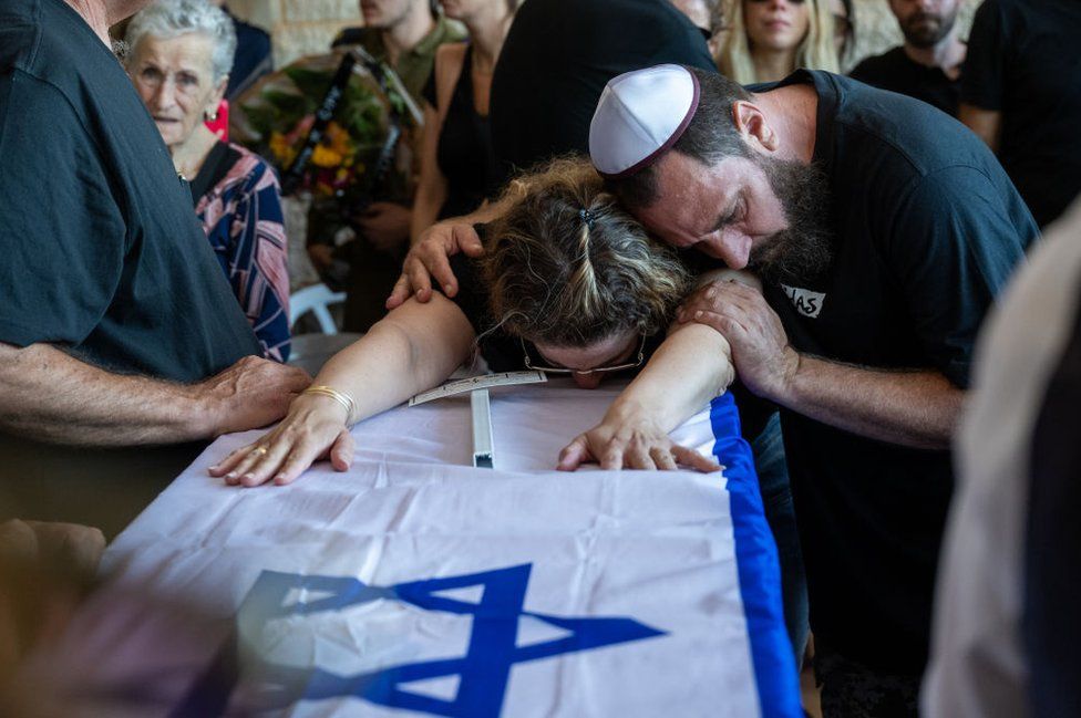 The family of Yitzhak Seitan, 76, his wife, Hannah Seitan, 73, their son, Tal Seitan, 49, and his aunt Pesi Cohen, 68, grieve during the funeral at the Hod Hasharon cemetery, 18 October 2023